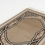 Beige prayer mat close-up with brown and white ornate arch border