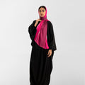 Pink prayer scarf with light trim, worn with black long robe