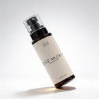 Bottle of 'Pure Musk' perfume spray on a light gray background