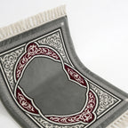 Prayer mat with dark grey base and heart-shaped arch design in red and white trim