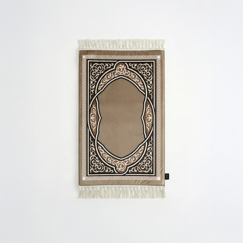 Padded prayer mat with beige border, dark arch medallion, and white fringe tassels
