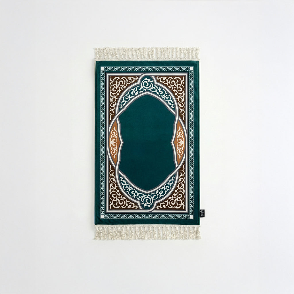Padded prayer mat with dark teal border, teal arch medallion, and white fringe tassels