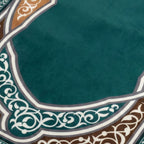 Padded prayer mat close-up of teal surface with ornate border edging