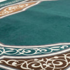 Padded prayer mat close-up of teal fabric and decorative border trim