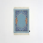 Padded prayer mat with blue border, blue arch medallion, and white fringe tassels