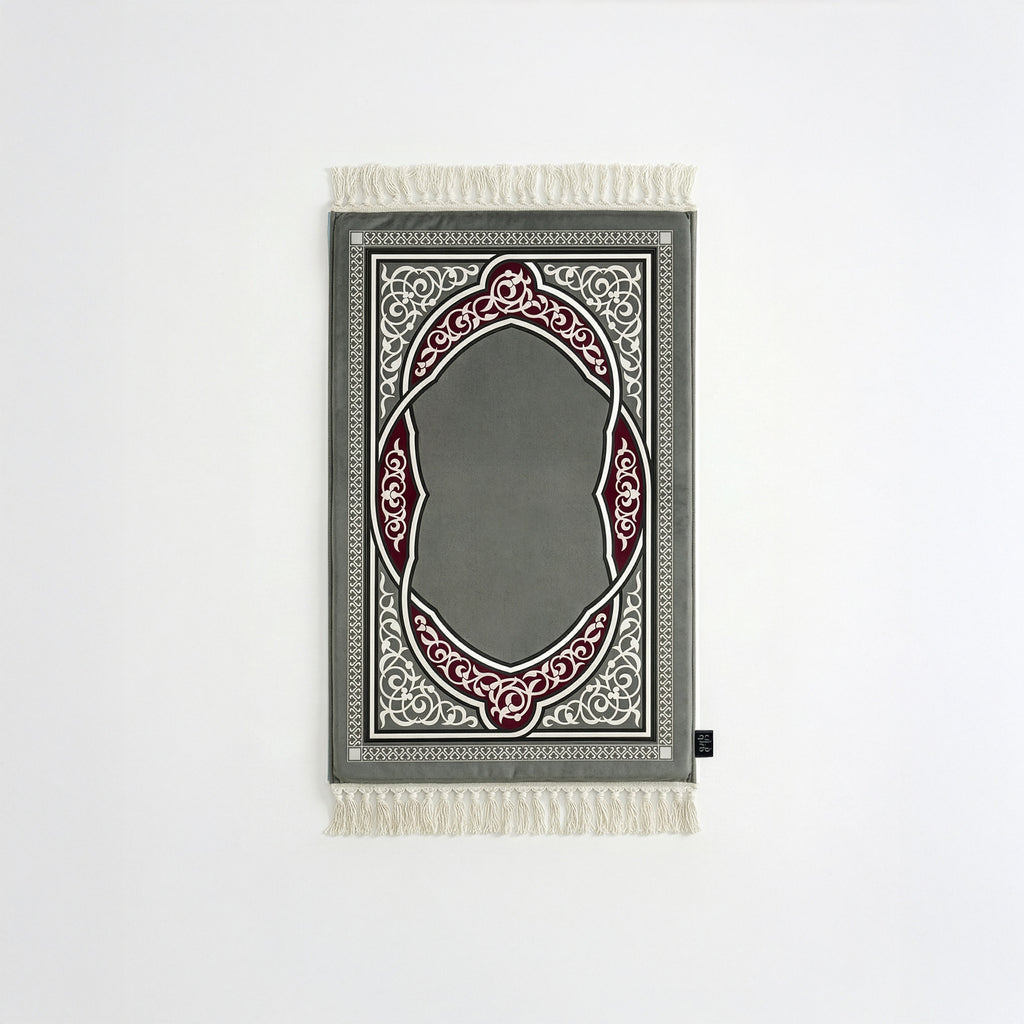 Padded prayer mat with gray border, gray arch medallion, and white fringe tassels