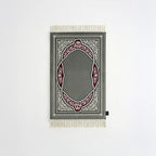 Padded prayer mat with gray border, gray arch medallion, and white fringe tassels