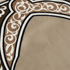 Padded prayer mat close-up of beige surface with brown decorative border