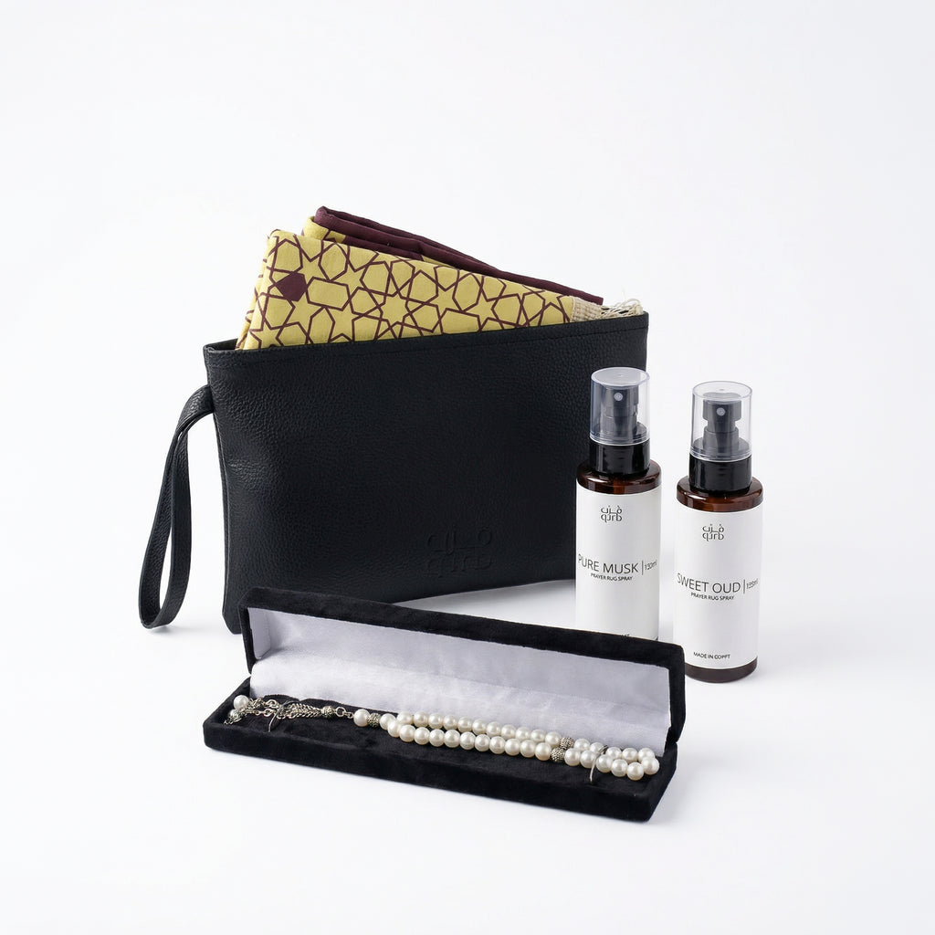 Open gift set tray with black organizer, prayer beads, and two rug spray bottles
