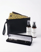 Open gift set tray with black prayer beads, black case, and two rug spray bottles