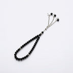 Black beaded prayer bracelet with crescent charms and silver-tone chain