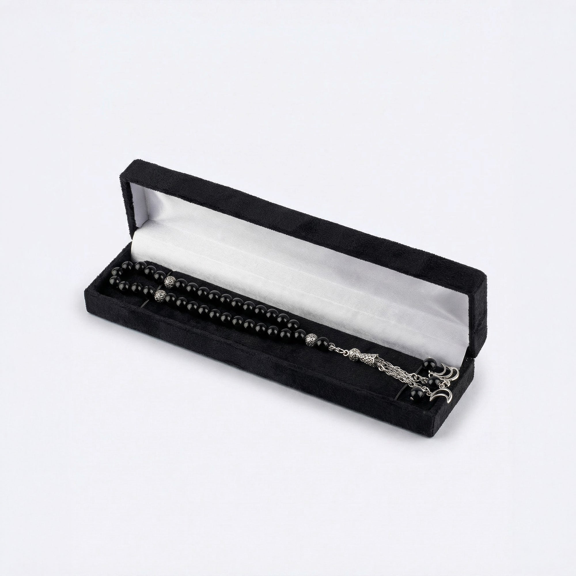 Black beaded prayer set in black velvet box with silver-tone chain and charms