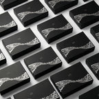 Multiple black gift boxes with white decorative calligraphy on the lids