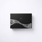 Black gift box front with silver-gray decorative calligraphy design